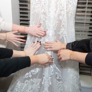 Bridal party wearing matching permanent jewelry bracelets before wedding