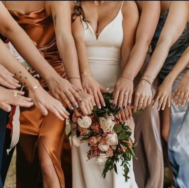 Women wearing permanent jewelry at a St. Louis bridal jewelry party