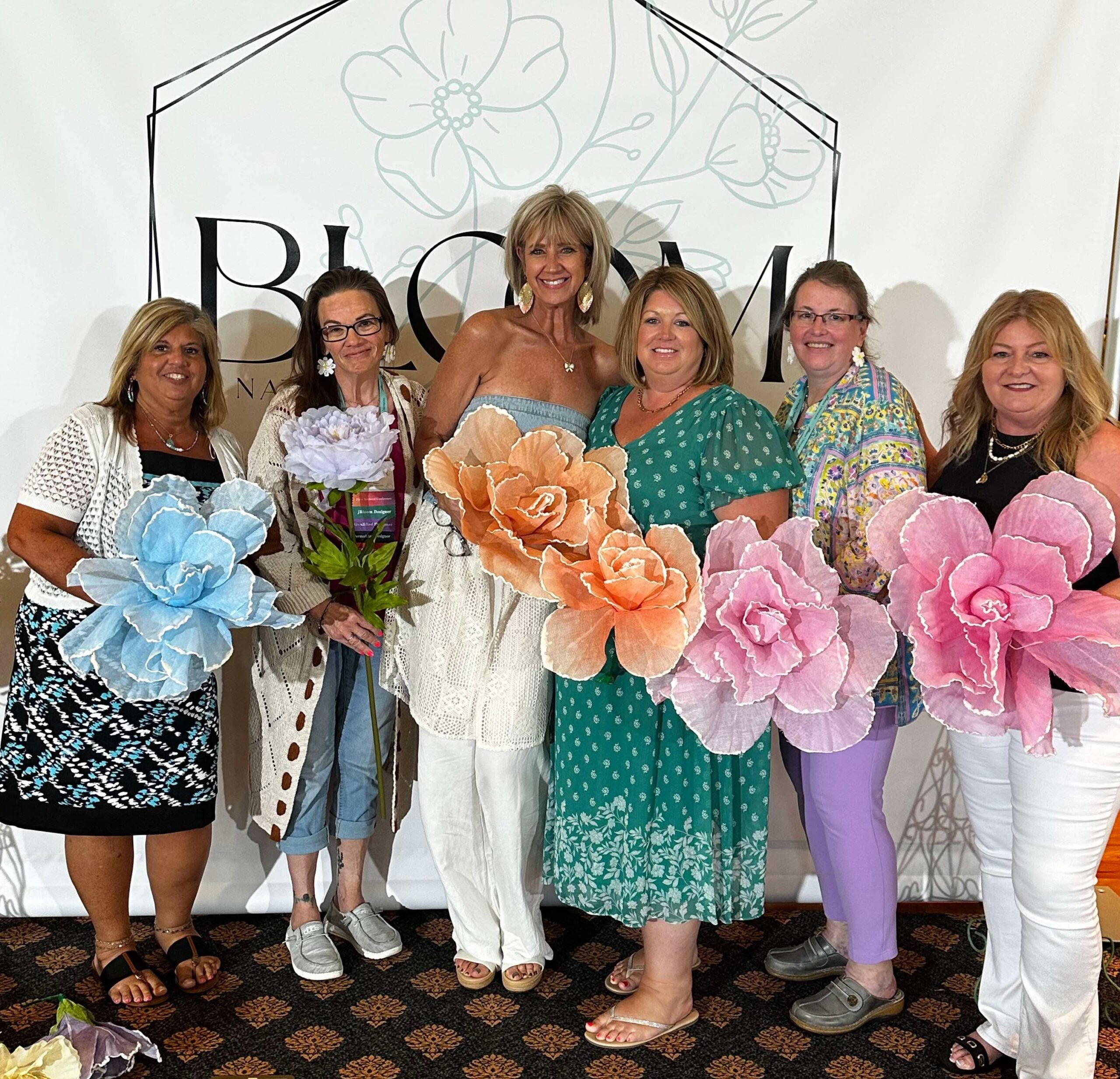 Women celebrating connection and confidence through the Blooming with Lori permanent jewelry community.