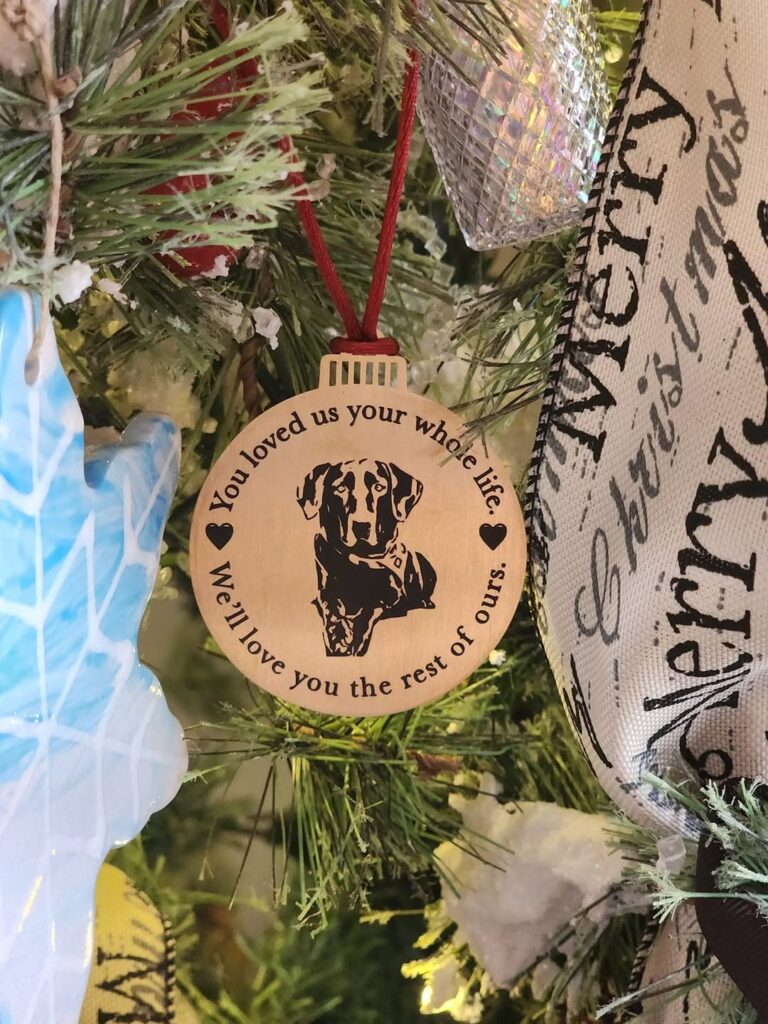 Engraved pet memorial ornament with a dog portrait reading You loved us your whole life, we'll love you the rest of ours